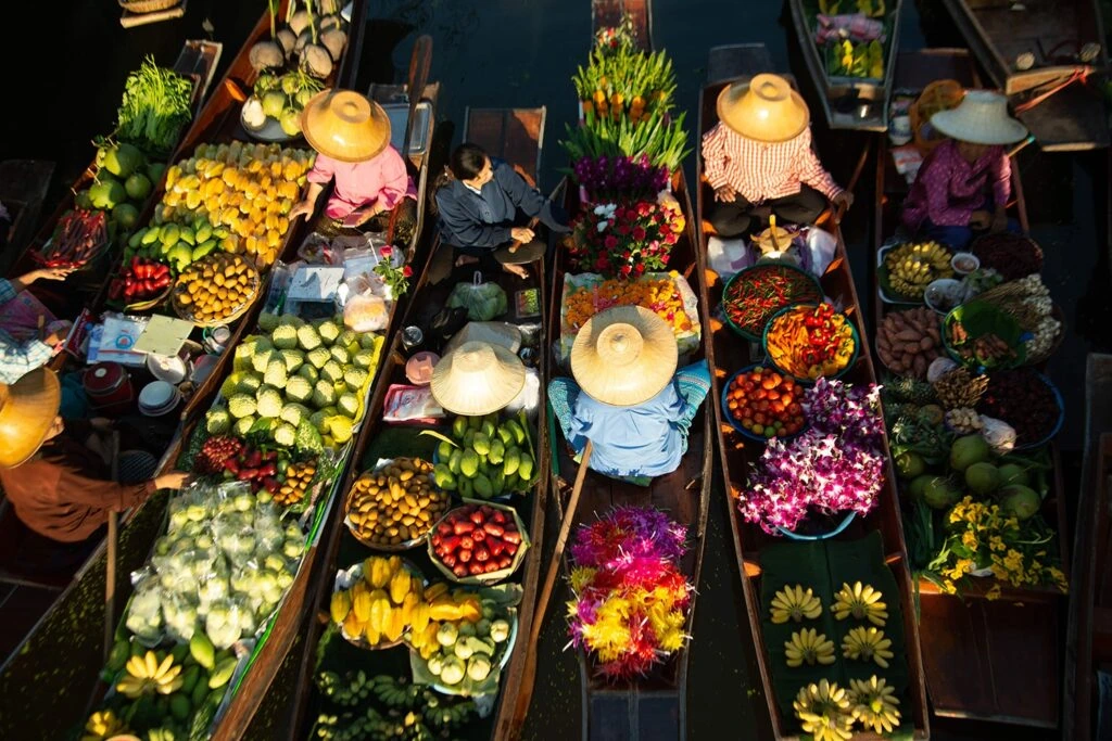 Floating market boats loaded with colourful fruit and vegetables