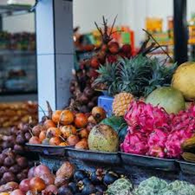Fresh fruit display with dragon fruit, grapes and pineapple