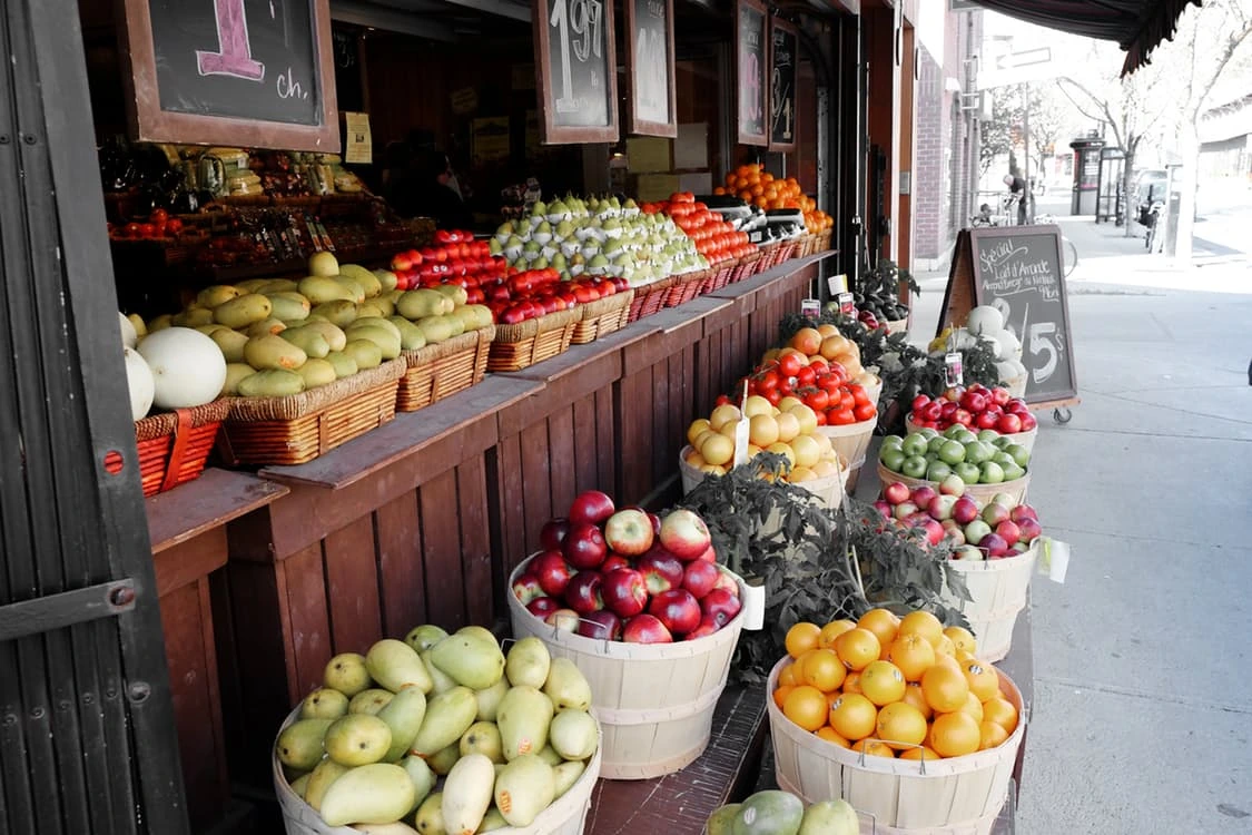 Street-side fruit shop with baskets of fresh produce
